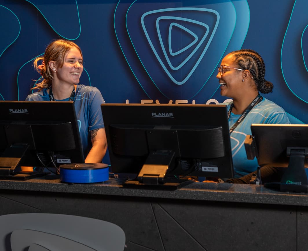 LEVEL99 EMPLOYEES SMILING BEHIND A COUNTER